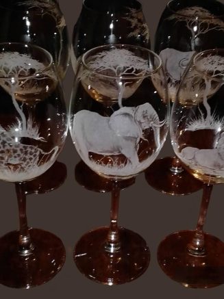 a group of wine glasses with animals and giraffes